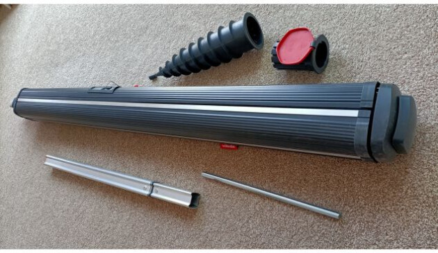 The parts of the Vileda Sun-Rise 50m Outdoor Rotary Clothes Dryer laid out on a light brown carpet