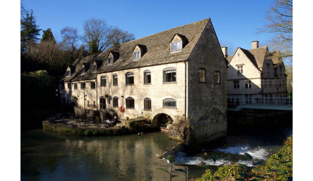 a riverside cafe with a water mill