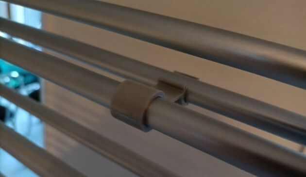A close up of the plastic grey clip on the aluminum airer