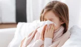 a girl blowing her nose