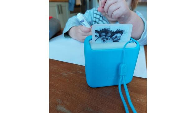 a toddler playing with a yoto mini