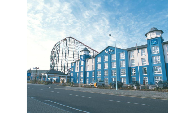 Big Blue Hotel in Blackpool, with a rollercoaster in the background