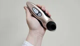 A Mumsnet editor's hand holds the Womanizer X Lovehoney Pro40 sex toy against a cream wall