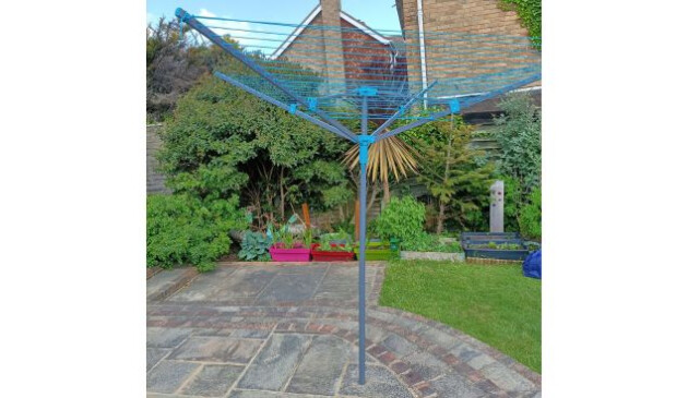 The Beldray 60m rotary airer standing open on a patio