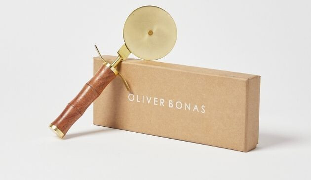 A brass pizza cutter with bamboo-style handle from Oliver Bonas