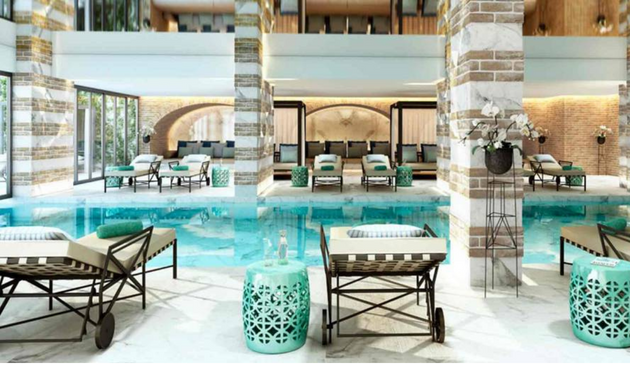 a fancy swimming pool with ornate columns