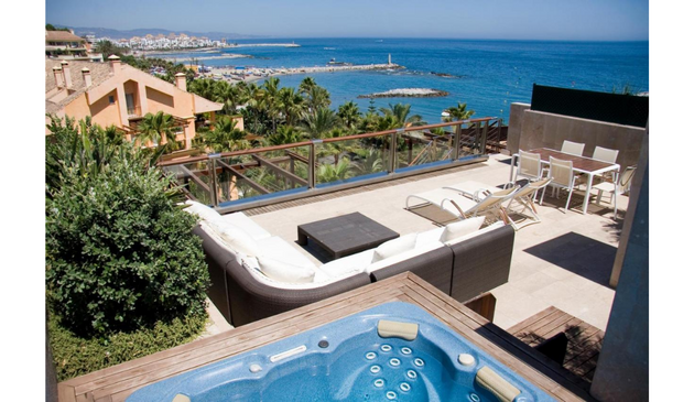 a view of the sea from a balcony hot tub