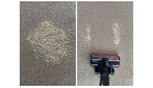 The brush head of a Henry Quick hoovering up porridge oats off a light brown carpet