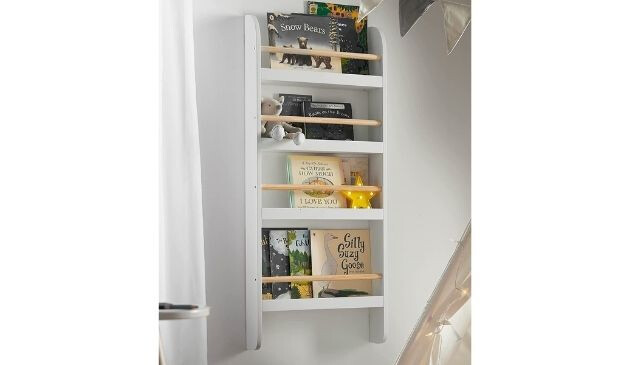 A white bookcase which has been mounted to the wall.