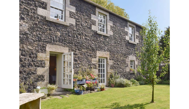a grand house with a lawned garden