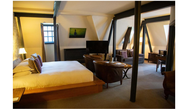 a rustic hotel room with wooden beams