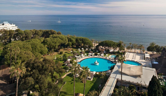 aerial view of a round swimming pool near the sea