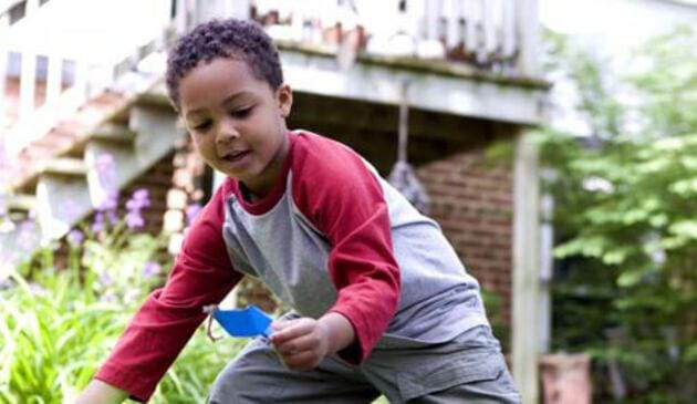 Child digging with plastic spade