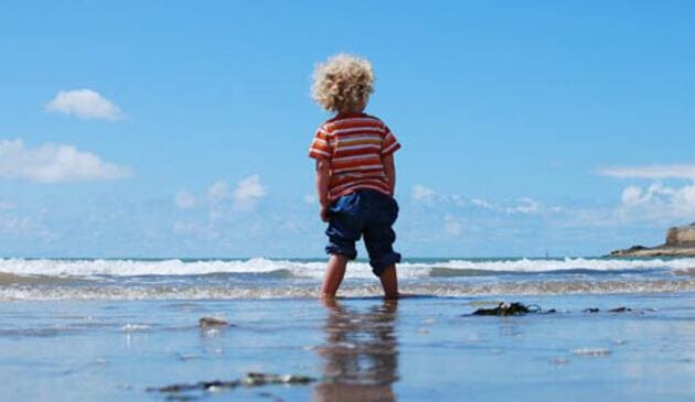 Toddler paddling in the sea