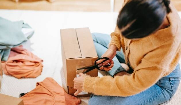 Woman returning clothes in a box