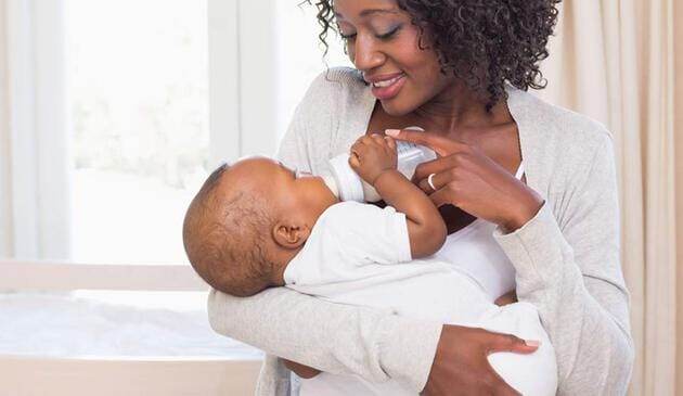 mum feeding baby with bottle