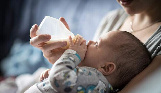baby feeding from a bottle