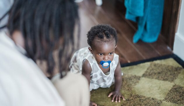 Baby crawling with parent