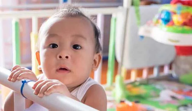 Baby in cot main