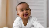 Baby laughing at camera