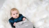 baby lying down with present