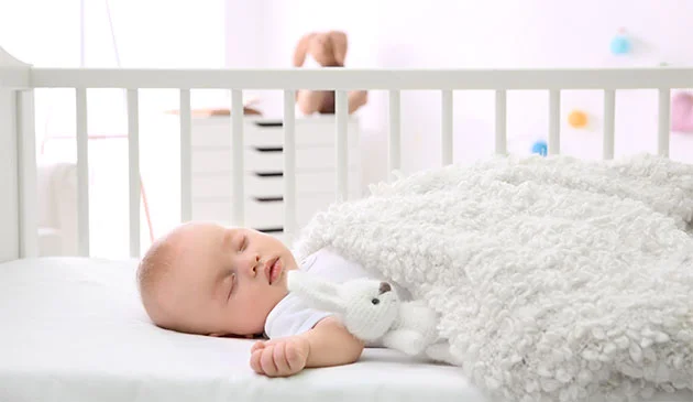 Baby sleeping in cot