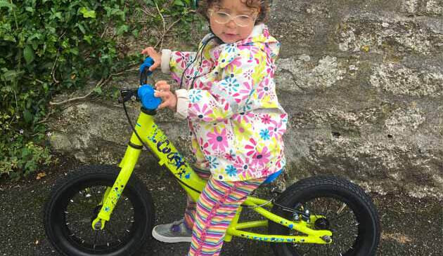 child on balance bike