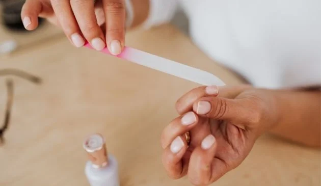woman filing nails at home