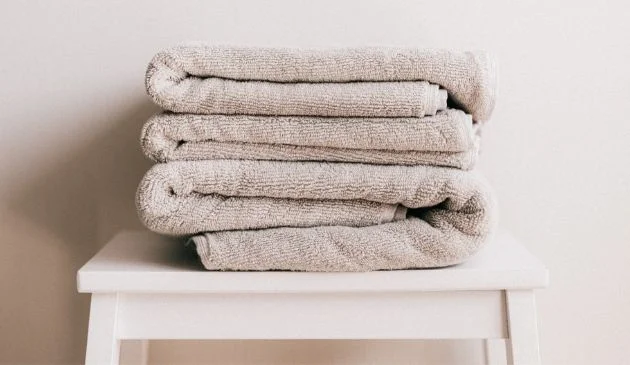 pile of bath towels on a table