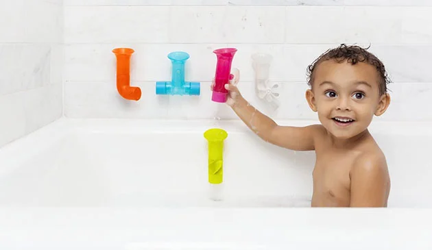 Toddler playing in the bath