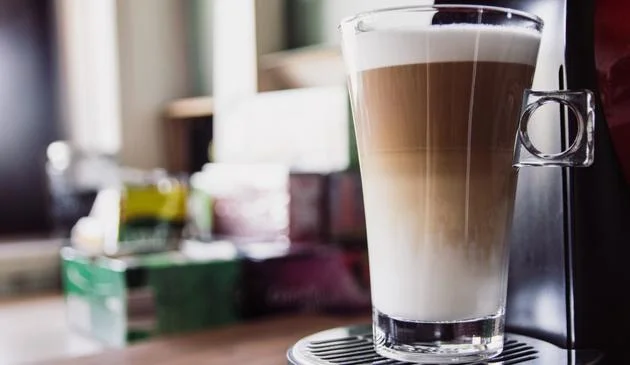 A latte glass filled with fresh coffee