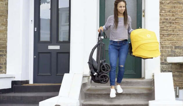 woman walking down steps carrying bugaboo bee 6 pushchair