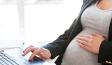 Woman at laptop touching bump