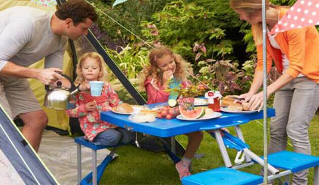 Family eating dinner outside tent