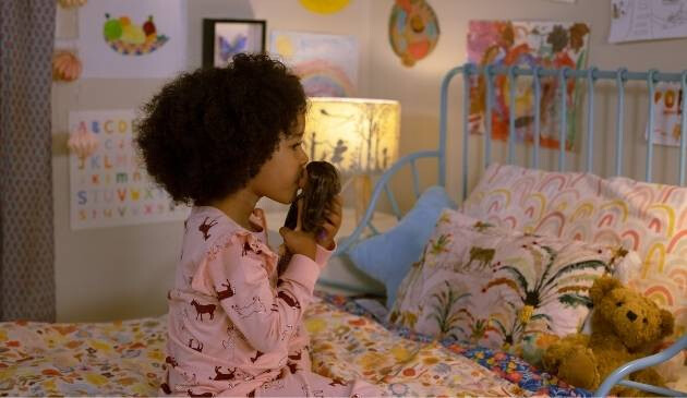child at bedtime with Barbie doll