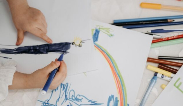 A child drawing a colourful picture