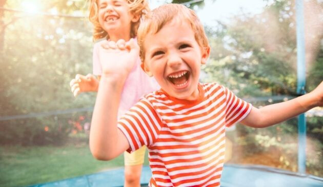 two children playing on trampoline