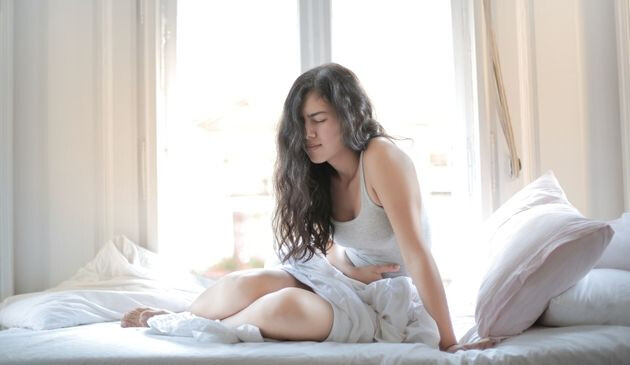 Woman in pain holding stomach