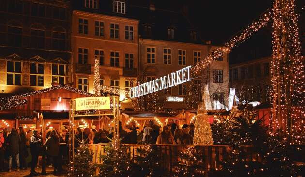 Copenhagen Christmas market with lights and revellers