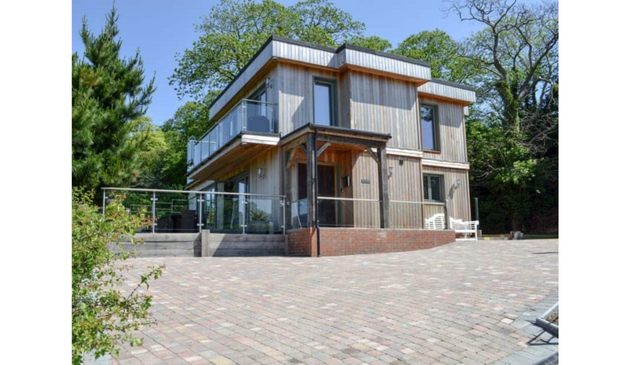 a modern home with a paved driveway