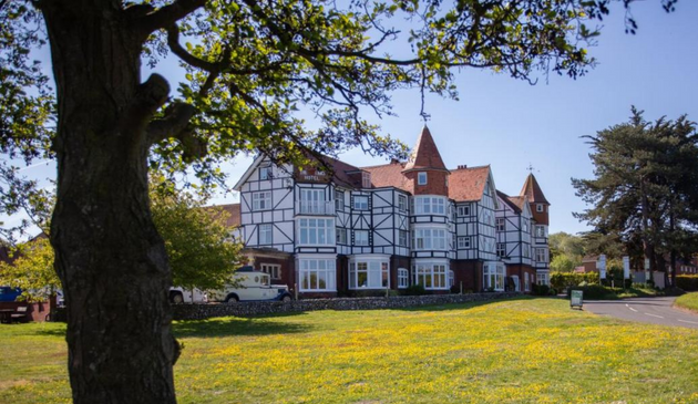 a mock tudor hotel on a sunny day