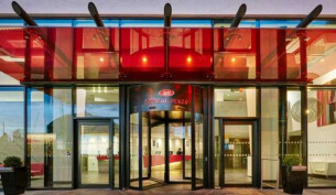 The glass doors entrance to Crowne Plaza