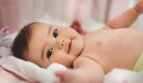 Cute baby lying on blanket