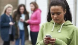sad girl looks at phone