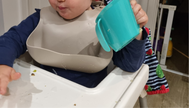 Toddler holding Doidy Cup
