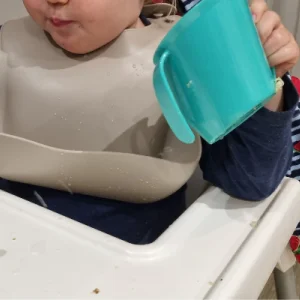 Toddler holding Doidy Cup