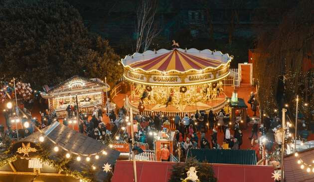 A carousel lit up at night, at Edinburgh's Christmas market