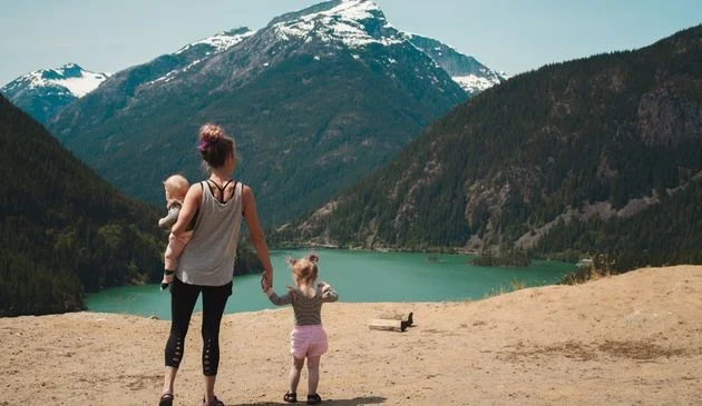 Woman with two kids overlooking a mountain
