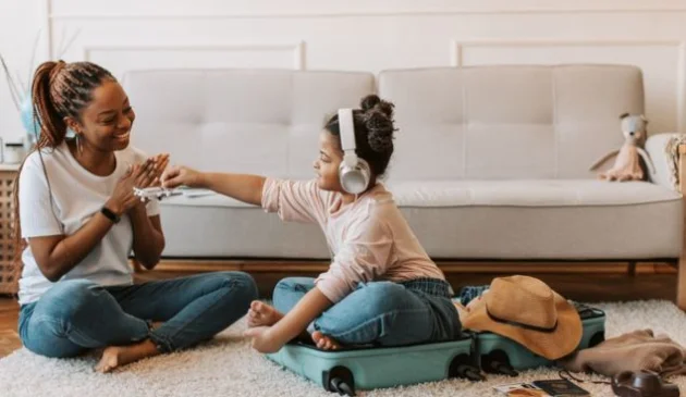 Mother and daughter packing a suitcase