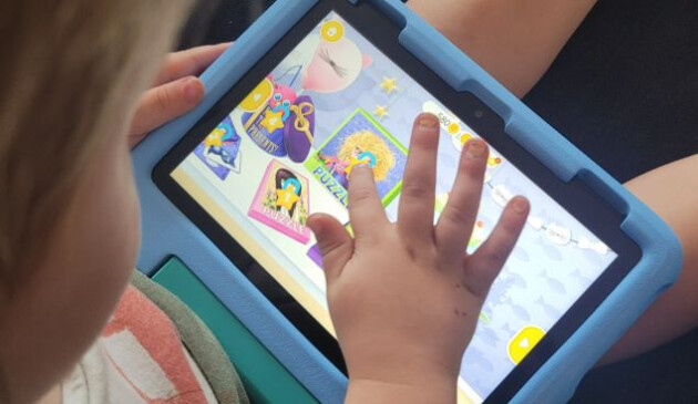 Child testing an Amazon Fire tablet
